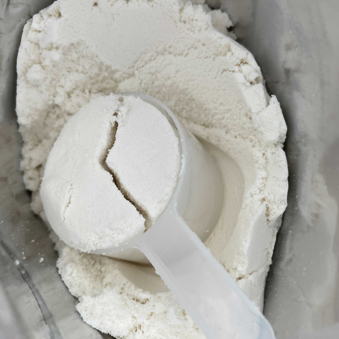 Organic Grass-Fed Whey Protein Isolate - Unflavored Image of Powder and a Scooper